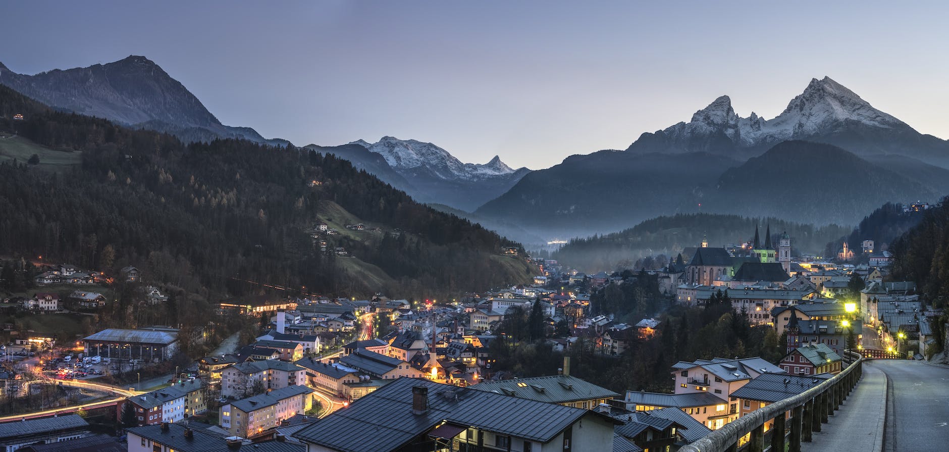 birdseye photography of city buildings near trees and mountains